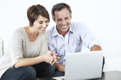 Couple sitting in front of computer