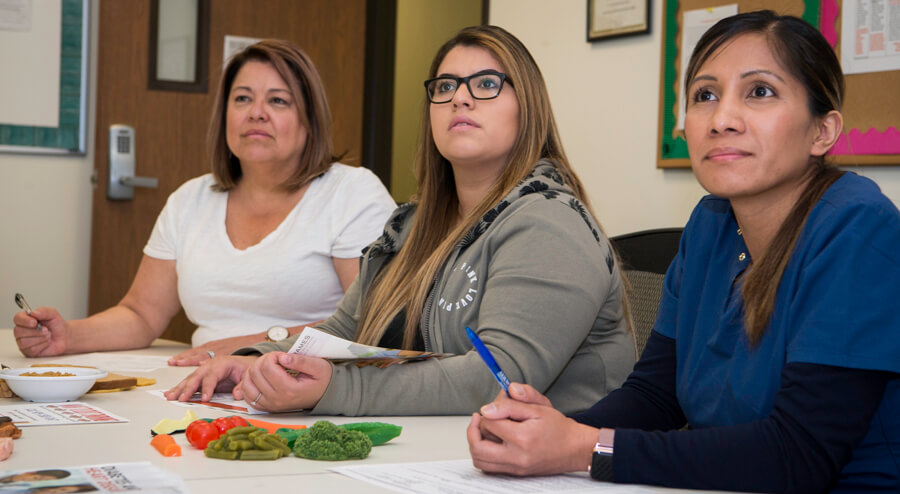 3 students listening in classroom