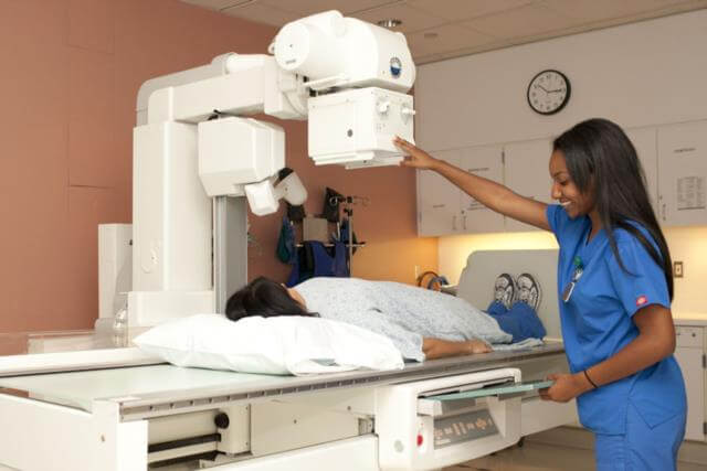 nurse using radiography machine