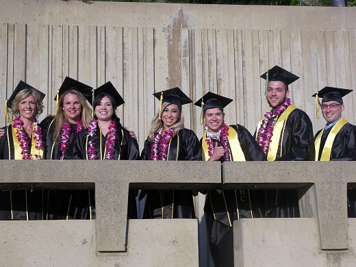 Students posing in graduation gowns